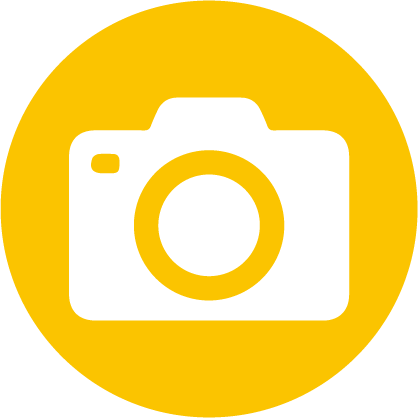 White camera icon on a yellow circle